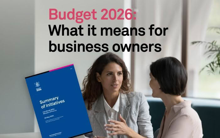 Two women discussing NZ Budget 2026 in the office